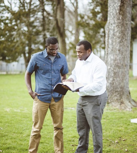 african-american-male-friends-standing-park-discussing-bible